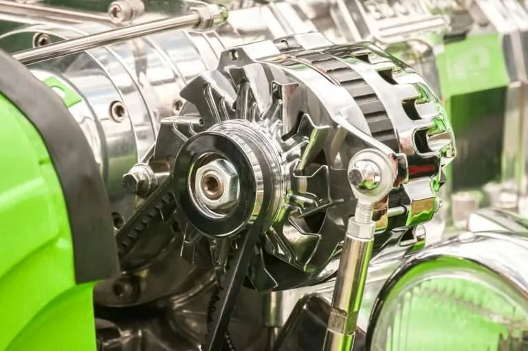 Close-up of an alternator and drive pulley on an engine
