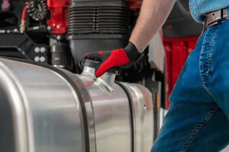 Mechanic working on a fuel tank and fuel delivery components
